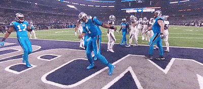 Football Players In Blue Uniforms Dancing On Field GIF