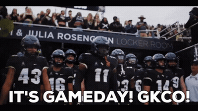 Football Players In Front Of It's Gameday Sign GIF