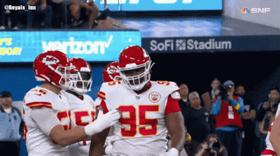 Football Players In Front Of SoFi Stadium Sign GIF