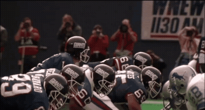 Football Players In Giants Helmets Huddling GIF
