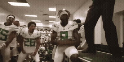 Football Players In Green And White Dancing In Hallway GIF