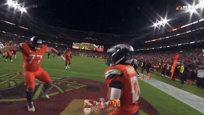 Football Players In Helmets Standing Together GIF
