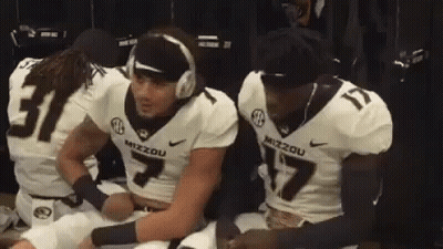 Football Players In Locker Room One With Headphones GIF