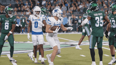Football Players In Memphis Uniforms On Field GIF