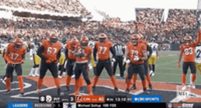 Football Players In Orange Uniforms On Field GIF