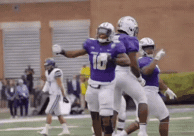 Football Players in Purple and White Celebrating Touchdown