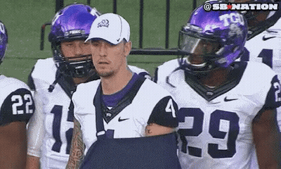Football Players In Purple And White Uniforms Number 29 GIF