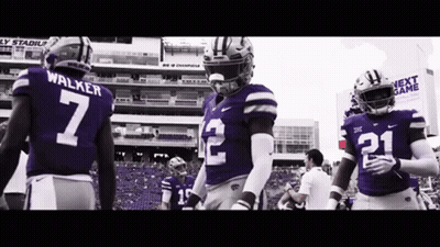 Football Players In Purple Uniforms Standing On Field GIF