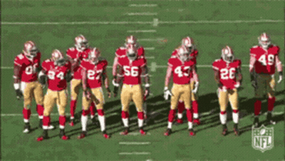 Football Players In Red And Gold Uniforms Number 56 GIF