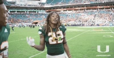 Football Players In Red And White Uniforms Huddled Together GIF