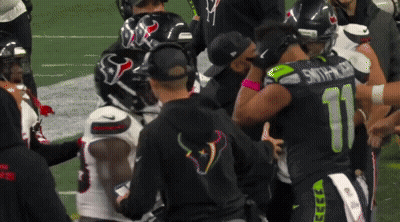 Football Players Including Number 11 Huddled Together GIF