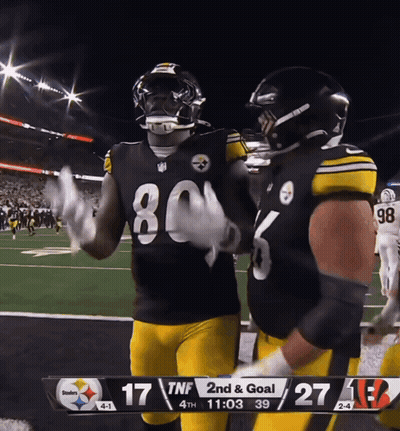 Football Players Near Scoreboard GIF