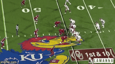 Football Players On A Field With A Ku Logo GIF