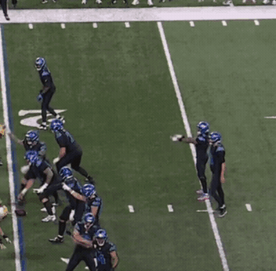 Football Players On Field With Number 18 Jersey GIF