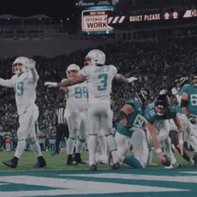 Football Players On Field With Quiet Please Sign GIF
