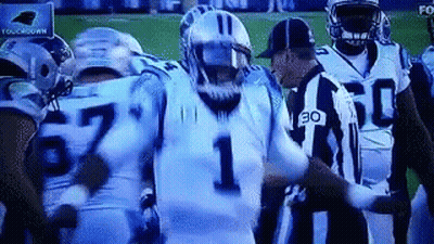 Football Players On Field With Referee GIF
