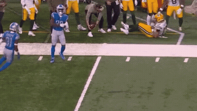 Football Players Playing, One Lying GIF