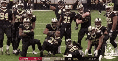 Football Players Posing On Field GIF