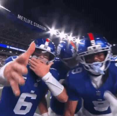 Football Players Posing On Field GIF