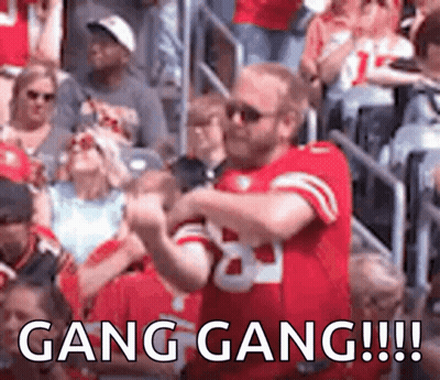Football Players Running Across Field GIF