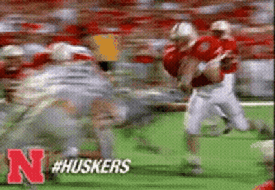 Football Players Running On Field With Letter N GIF