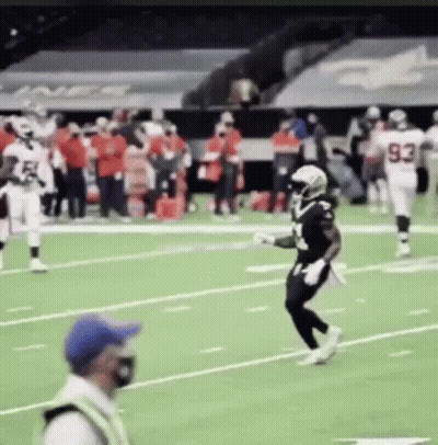Football Players Running On Field With Referee GIF