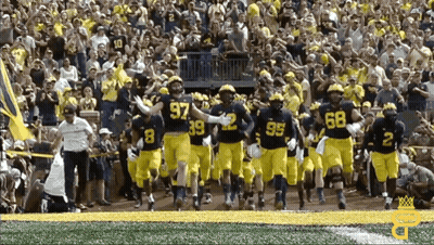 Football Players Running With Number 97