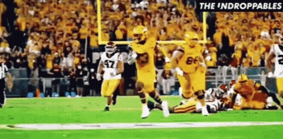 Football Players Running With Referee GIF