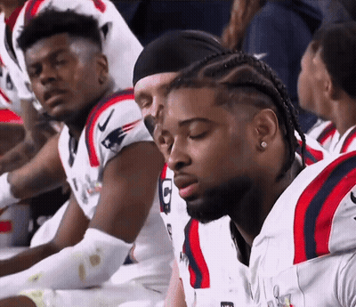 Football Players Sitting In Row With Letter G Jersey GIF
