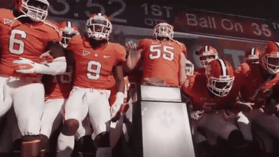 Football Players Standing In Front Of Ball On 38 Sign GIF