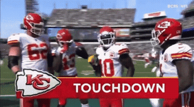 Football Players Standing In Front Of Touchdown Sign GIF