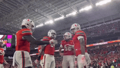 Football Players Standing In Stadium GIF