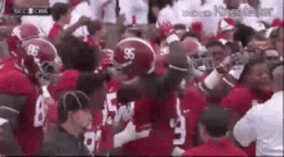 Football Players Standing In Stadium GIF