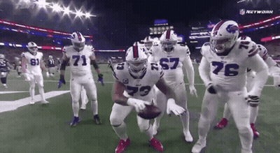 Football Players Standing On Field Holding Ball GIF