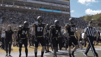 Football Players Walking On Field With Number 87 GIF