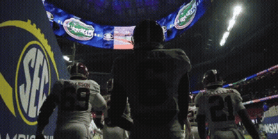 Football Players Walking Past Gators Sign GIF