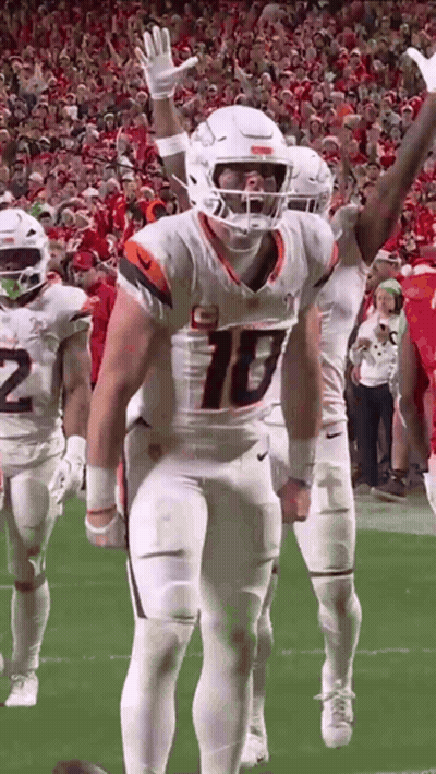Football Players With Arms In Air On Field GIF