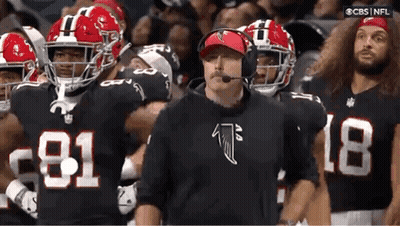 Football Players With Coach Wearing Headset GIF