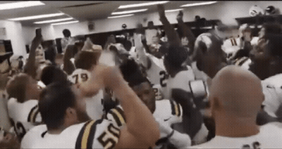 Football Players With Hands In The Air In Locker Room GIF