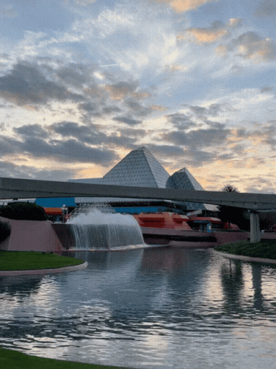 Fountain In Front Of Building With Pyramids GIF