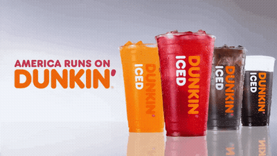 Four Cups Of Dunkin ' Iced Drinks Are Lined Up In Front Of A Sign That Says America Runs On Dunkin ' GIF