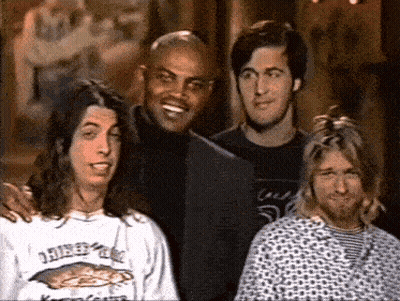 Four Men Posing One Wearing Nirvana Shirt GIF
