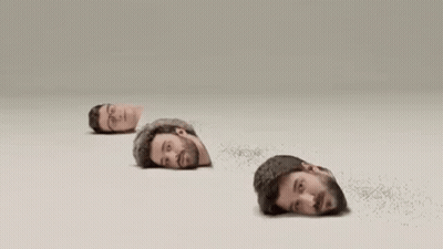 Four Men 'S Heads Are Sticking Out Of A Hole In The Ground . GIF