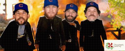 Four Men Wearing Blue Hats With The Letter C On Them Stand In Front Of A Fire GIF