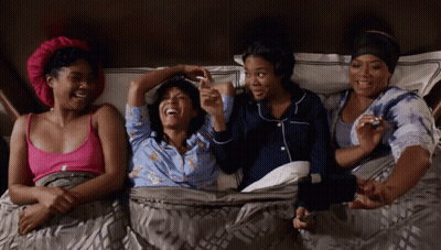 Four Women Laughing and Holding Hands