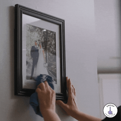Framed Bride And Groom Cleaned With Blue Cloth GIF