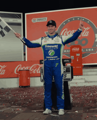 Freeway Uniform Man Holds Flag By Coca Cola GIF