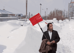 Freezing Confused Actor John Travolta With Signage GIF