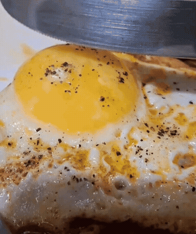 Fried Egg Being Cut With Knife GIF