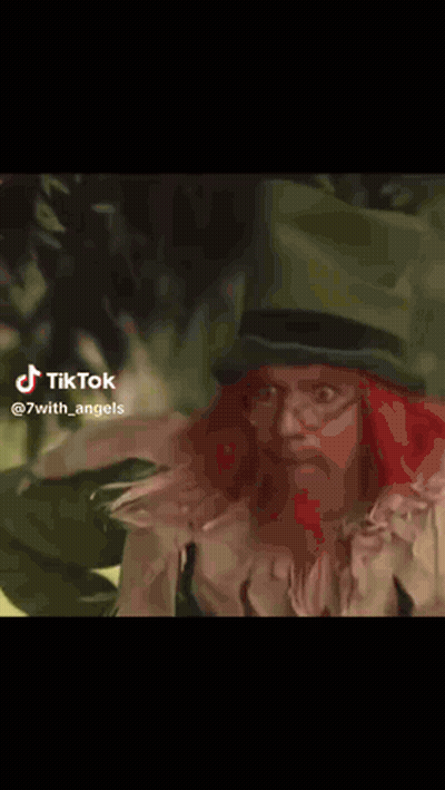 Frog In Red Dress And Black Cape Walking In Grass GIF